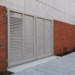 Louvered Gate on Bricked Wall