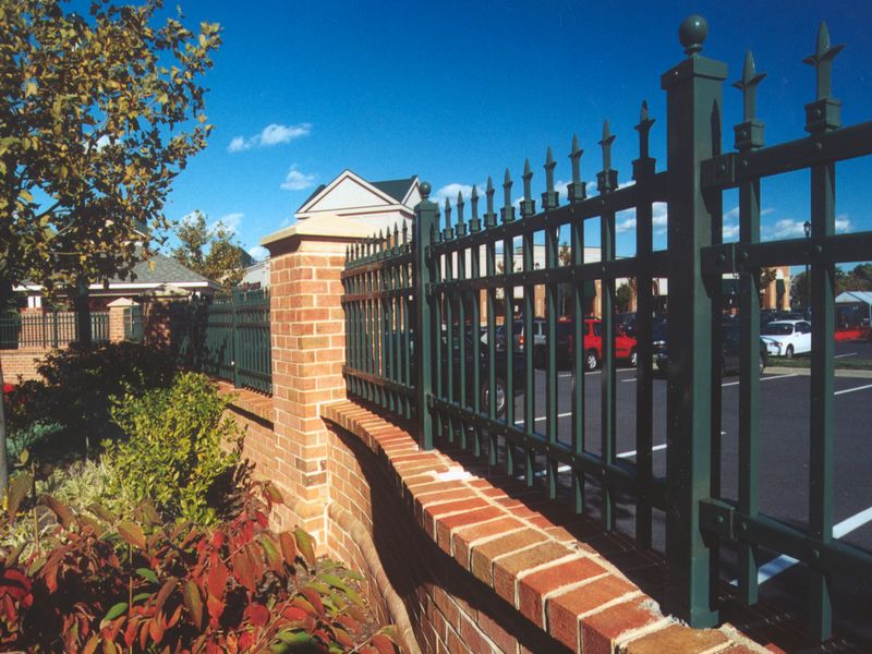 Ornamental Iron Custom Fence On Brick Wall