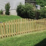 Wood Spaced Board Fence in Backyard Lawn