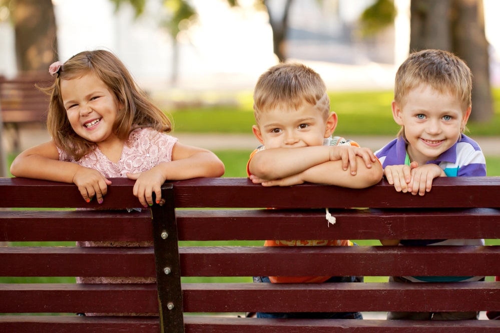 Children Looking Over Fence