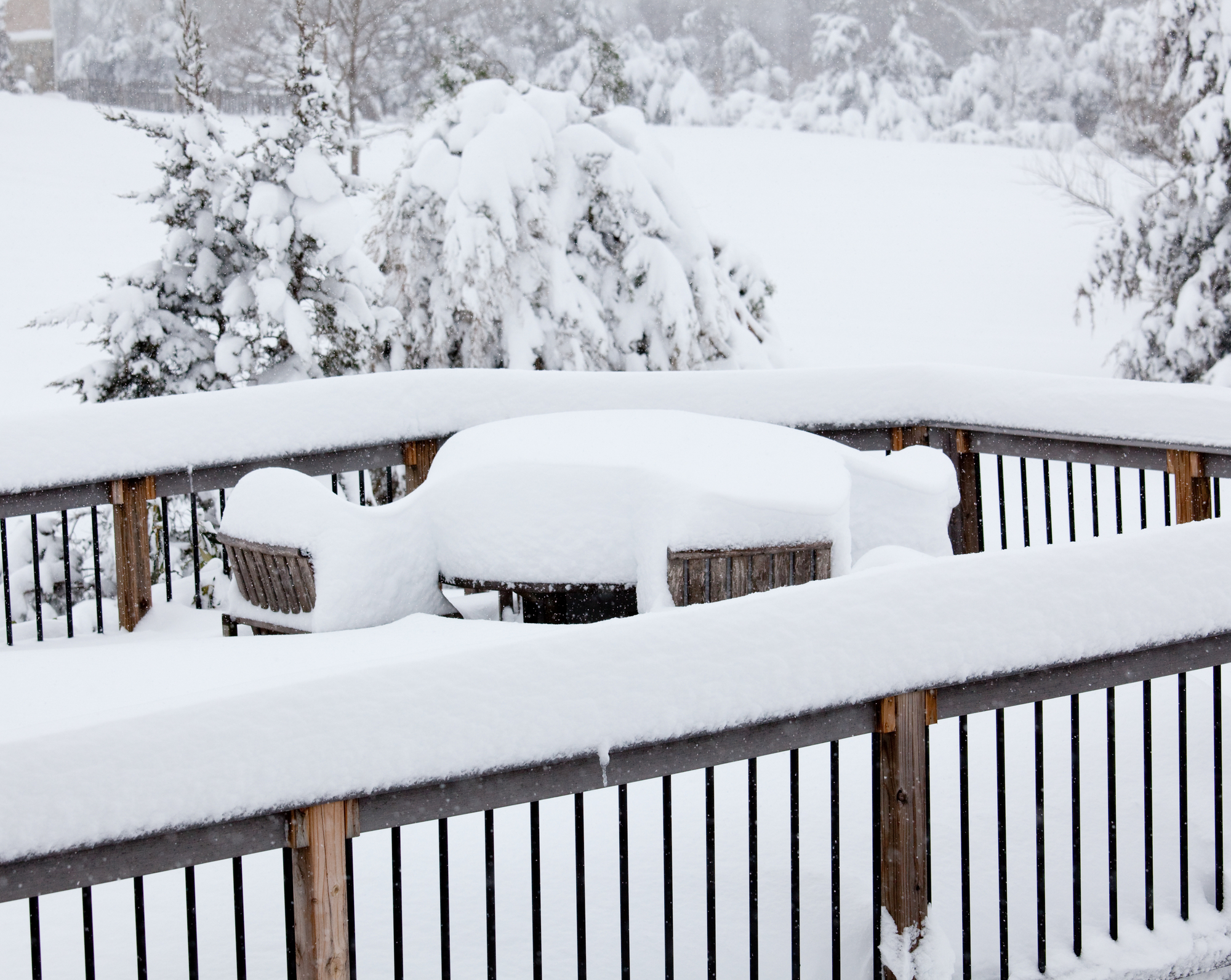 snow covered patio and rail fencing